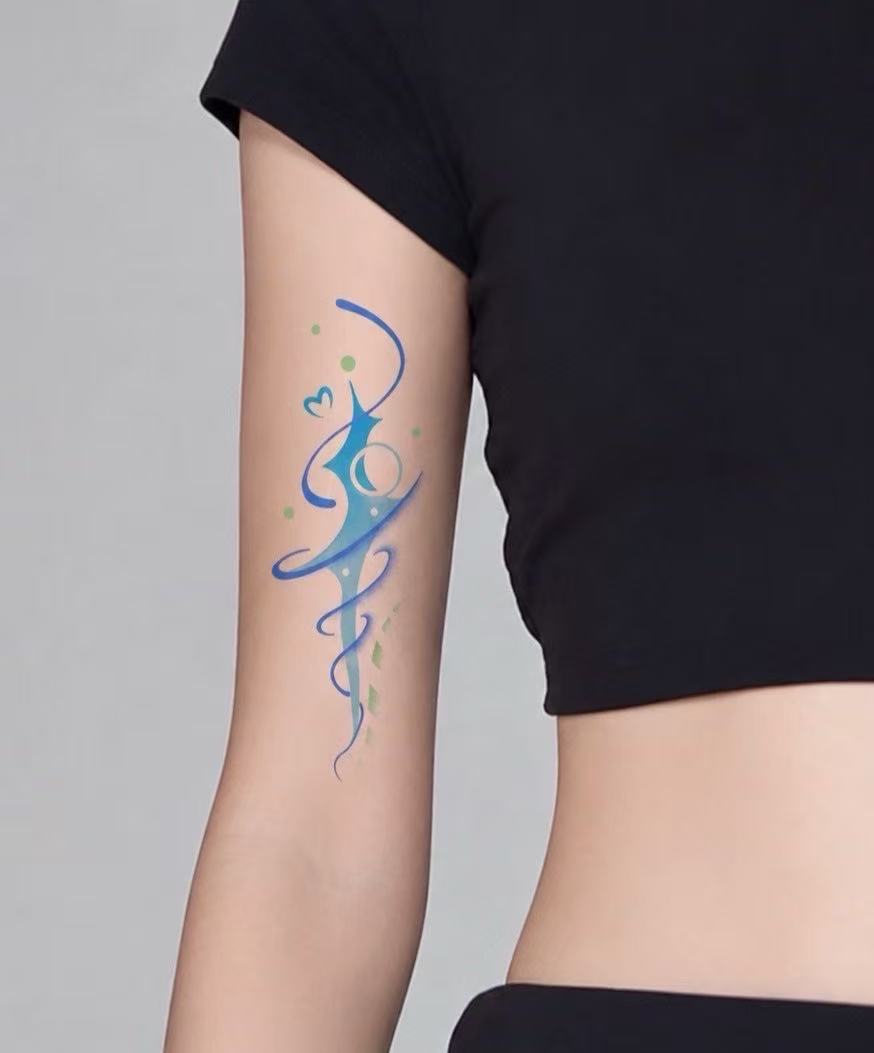 Blue and green abstract tattoo on arm
