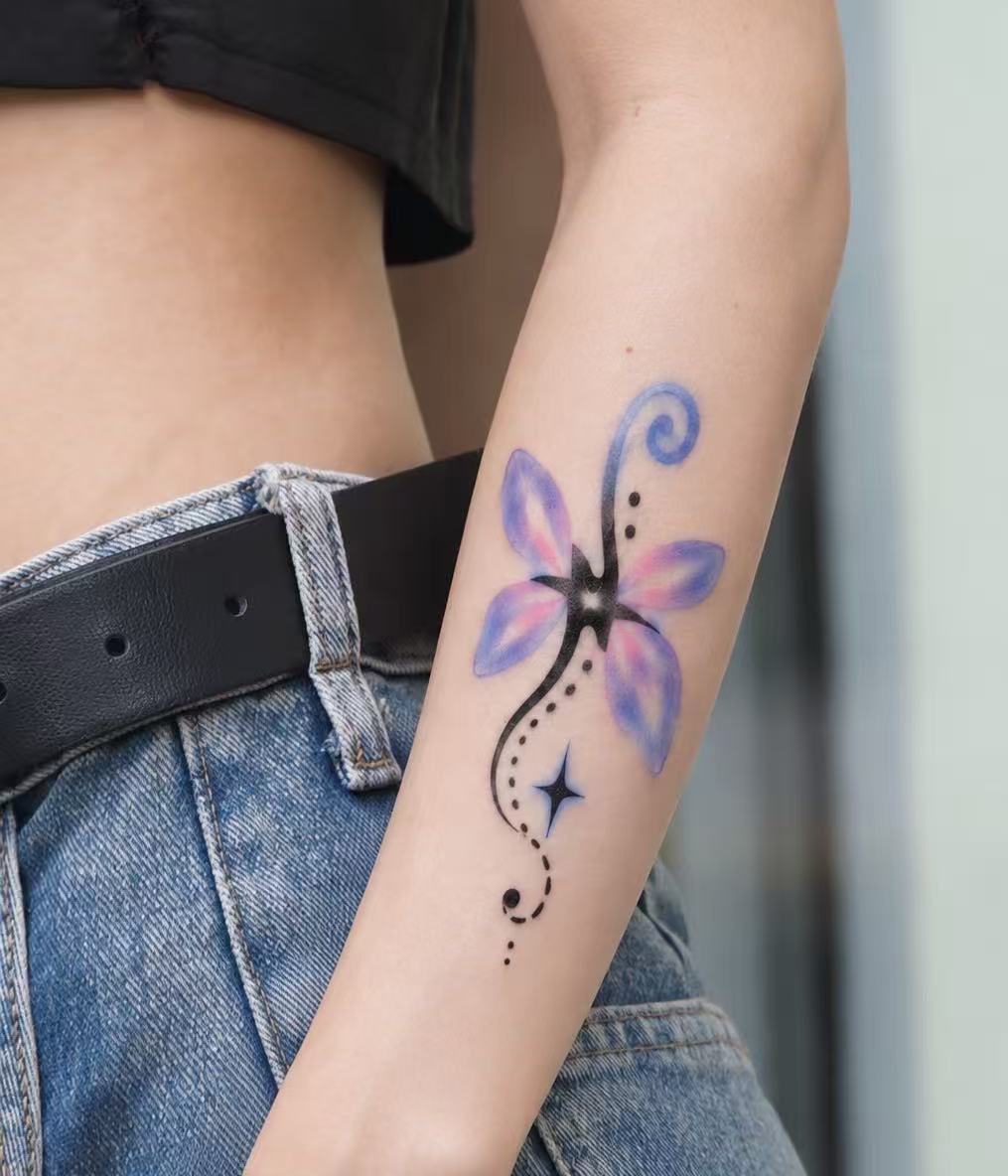 Purple flower tattoo on forearm