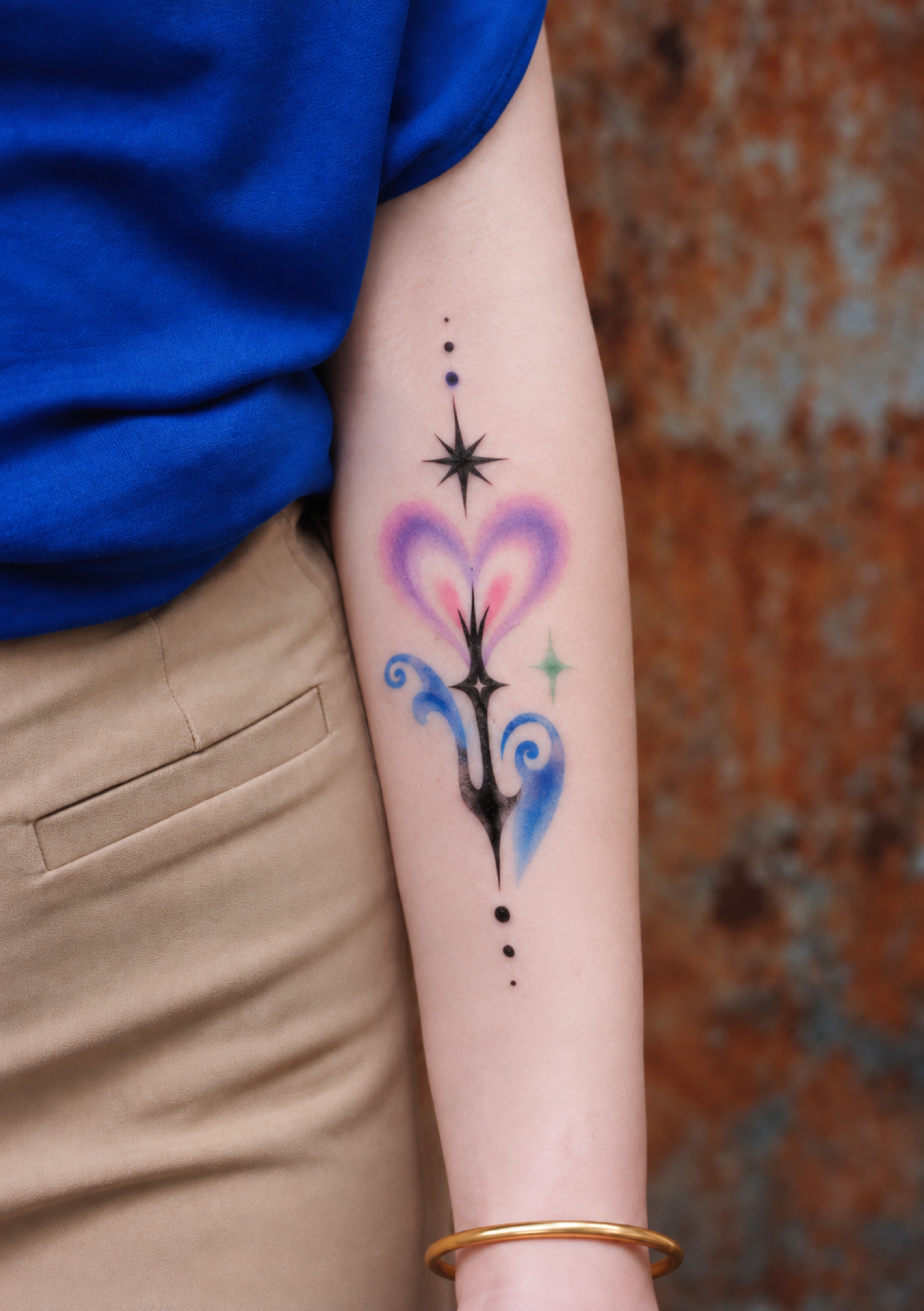 Abstract heart and star tattoo placed on forearm