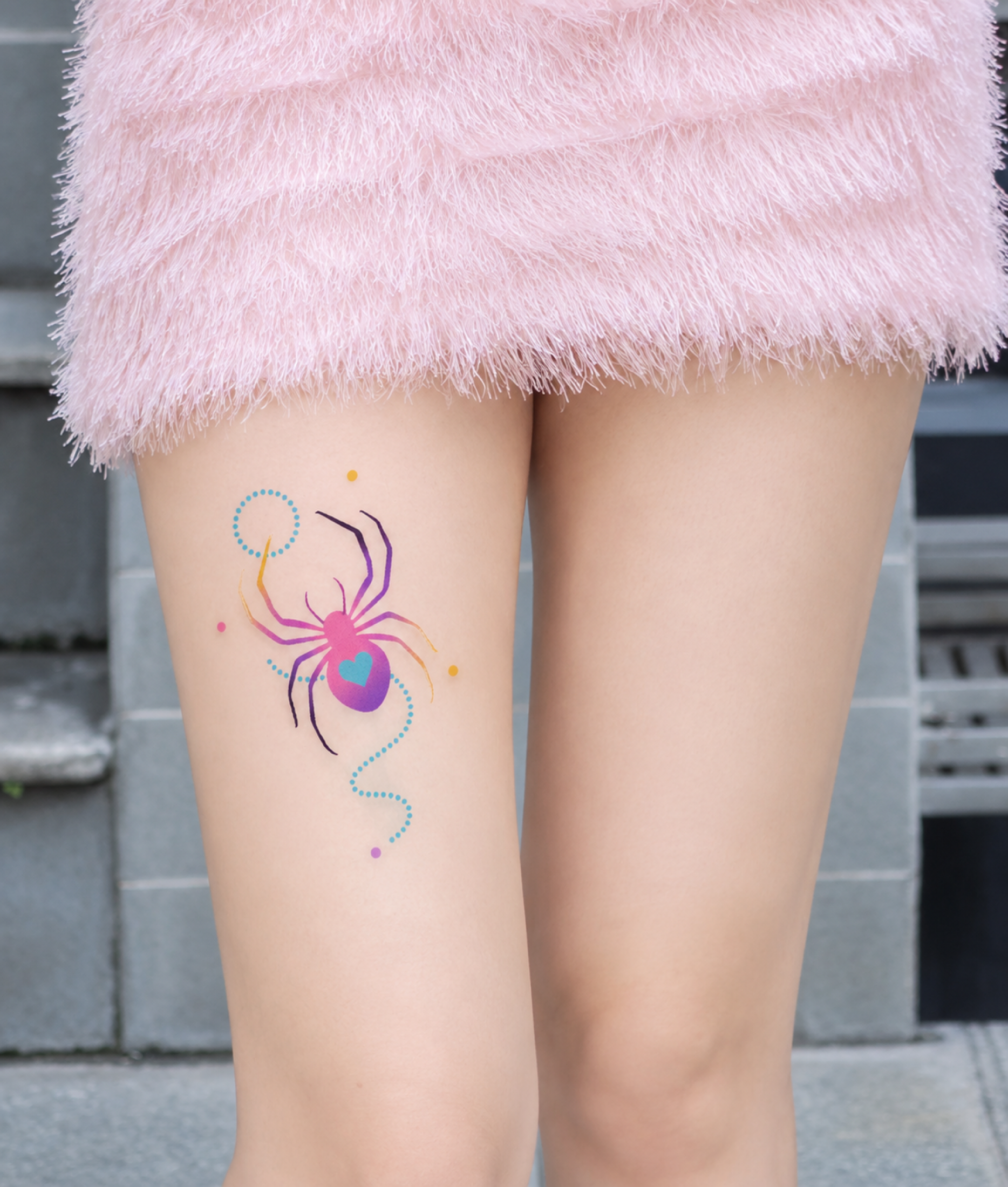Colorful spider tattoo placed on thigh