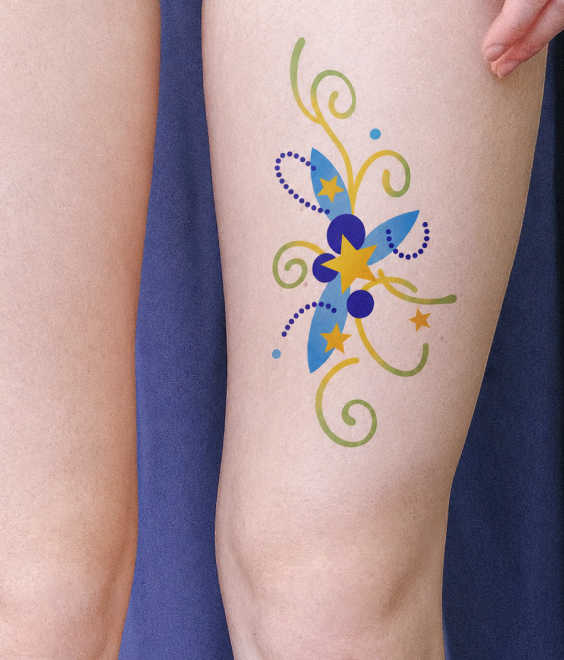 Blue star and vine tattoo placed on leg
