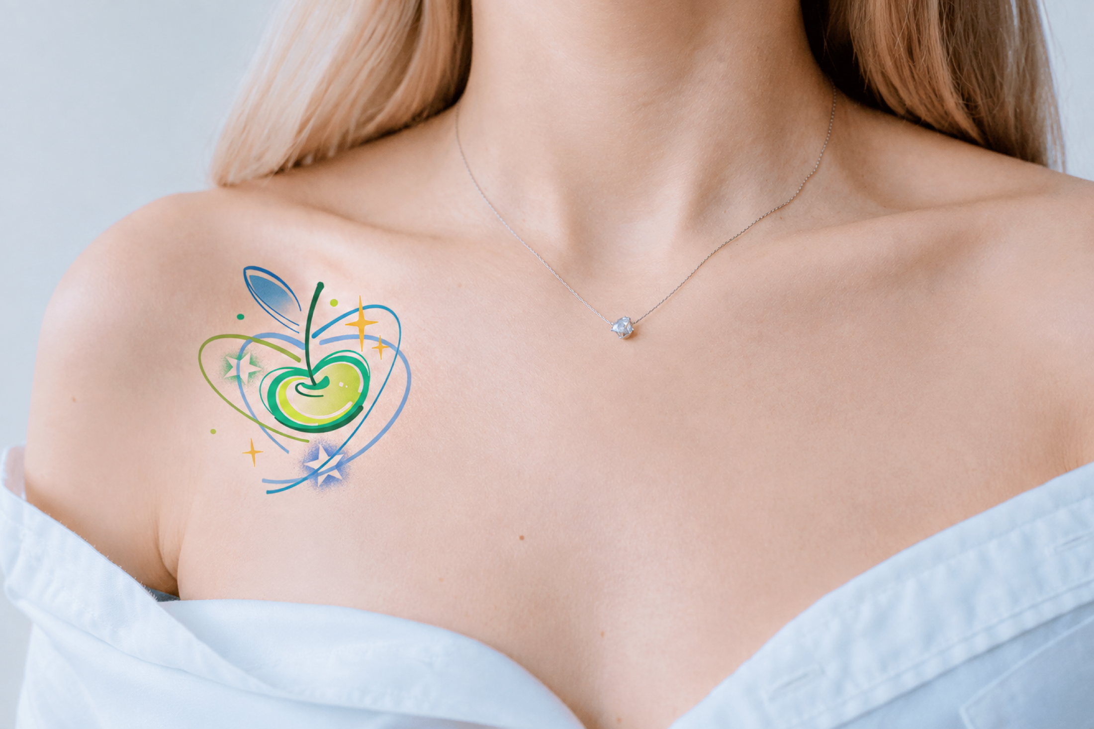 Green apple-heart tattoo placed on chest